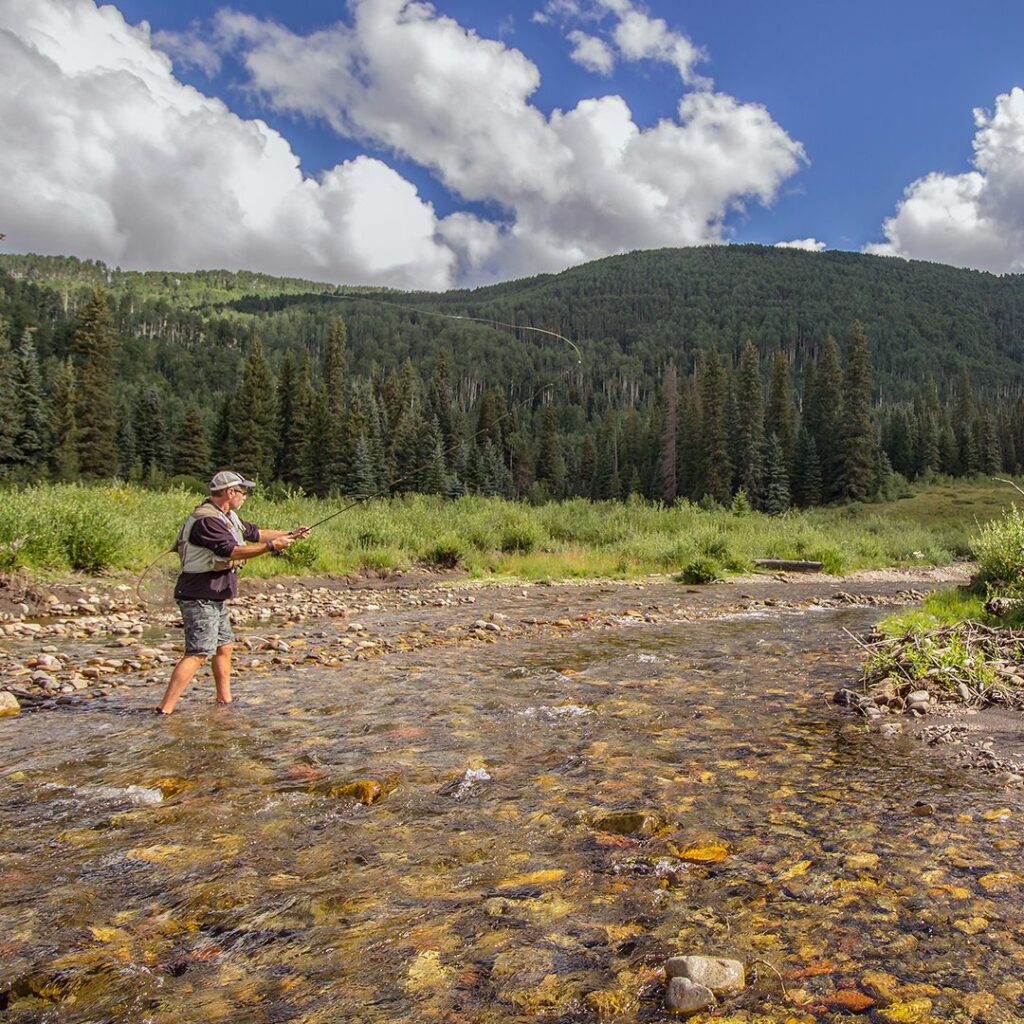 A photo in our best wet wading shoes guide shows are person fly fishing in Colorado.