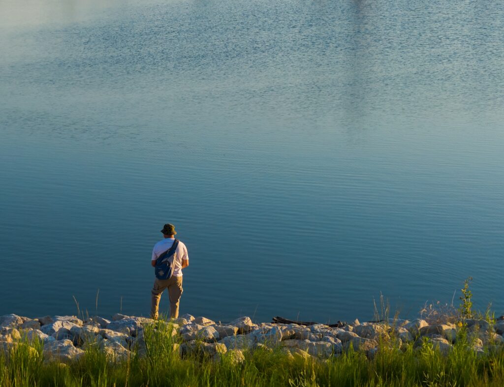 a man fishing with fly fishing backpack